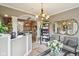 Reception area with chandeliers, mirrors, seating, and a glimpse into a salon space at 4732 Ferguson Rd, Indianapolis, IN 46239