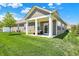 Relaxing back porch with an outdoor seating area and a well-manicured lawn under a bright, sunny sky at 4965 Eldon Dr, Noblesville, IN 46062