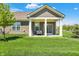 Inviting back porch with outdoor seating overlooking a lush green lawn and well-maintained landscaping at 4965 Eldon Dr, Noblesville, IN 46062