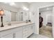Bathroom with dual sinks, quartz countertops, and a sliding barn door to the water closet at 4965 Eldon Dr, Noblesville, IN 46062