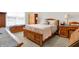 Cozy bedroom features wood furniture, neutral carpet, and a window for natural light at 4965 Eldon Dr, Noblesville, IN 46062