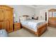 Bedroom with wooden furniture, neutral carpet, and a large bed with decorative pillows at 4965 Eldon Dr, Noblesville, IN 46062