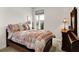Charming bedroom featuring a bed with a floral quilt, side table, and ample natural light at 4965 Eldon Dr, Noblesville, IN 46062