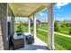 Comfortable covered patio featuring outdoor seating, providing a relaxing view of the landscaped common areas at 4965 Eldon Dr, Noblesville, IN 46062