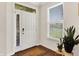 Well lit entry featuring a traditional white door, hardwood floors, side window, and plants at 4965 Eldon Dr, Noblesville, IN 46062