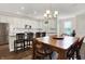 Open concept kitchen features stainless steel appliances, white cabinets, an island, and dining area at 4965 Eldon Dr, Noblesville, IN 46062