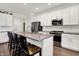Bright kitchen featuring white cabinets, stainless steel appliances, and a large island with seating at 4965 Eldon Dr, Noblesville, IN 46062