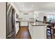 Well-lit kitchen showcases white cabinets, stainless steel appliances, and an island with barstool seating at 4965 Eldon Dr, Noblesville, IN 46062