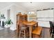 Open concept kitchen area featuring hardwood floors, white cabinets, dining table and bar seating at 4965 Eldon Dr, Noblesville, IN 46062