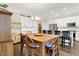 Open concept kitchen features white cabinets, an island with bar seating, stainless appliances, and hardwood floors at 4965 Eldon Dr, Noblesville, IN 46062