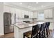 Stylish kitchen boasts white cabinets, stainless steel appliances, and a spacious island with barstools at 4965 Eldon Dr, Noblesville, IN 46062
