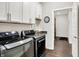 Practical laundry room equipped with modern washer, dryer, sink, and ample storage cabinets at 4965 Eldon Dr, Noblesville, IN 46062