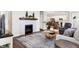 Open concept living room features a fireplace, hardwood floors, and seamless access to the kitchen at 4965 Eldon Dr, Noblesville, IN 46062
