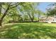 Expansive backyard featuring a well-maintained lawn, mature trees, and a privacy fence, ideal for outdoor activities at 5015 E 70Th E St, Indianapolis, IN 46220
