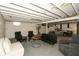 Unfinished basement is partially finished with furniture and painted rafters at 5015 E 70Th E St, Indianapolis, IN 46220