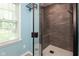 Newly renovated bathroom with frameless shower door and custom tile with bench seat at 5015 E 70Th E St, Indianapolis, IN 46220