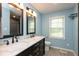 This bathroom has a double vanity, updated fixtures, and a window providing natural light at 5015 E 70Th E St, Indianapolis, IN 46220