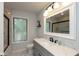 Bright bathroom featuring a shower-tub combo, marble countertop, and modern fixtures at 5015 E 70Th E St, Indianapolis, IN 46220