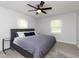 Charming bedroom featuring a ceiling fan, windows, and a comfortable queen-size bed at 5015 E 70Th E St, Indianapolis, IN 46220