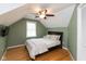 This bedroom features wood floors, a ceiling fan, and ample closet space at 5015 E 70Th E St, Indianapolis, IN 46220