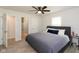This comfortable bedroom has a queen bed, ceiling fan and an ensuite bathroom with a walk-in closet at 5015 E 70Th E St, Indianapolis, IN 46220