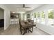 Bright dining area with a large table, stylish chairs, and expansive windows overlooking the outdoor space at 5015 E 70Th E St, Indianapolis, IN 46220