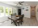 Dining area with a wooden table, comfortable seating, and large windows providing natural light and backyard views at 5015 E 70Th E St, Indianapolis, IN 46220