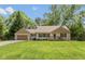 Charming single-story home with a manicured lawn, lovely front porch, and attached garage, perfect for suburban living at 5015 E 70Th E St, Indianapolis, IN 46220