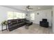 Bright living room with a comfortable sectional sofa, ceiling fan, and ample natural light from the large windows at 5015 E 70Th E St, Indianapolis, IN 46220