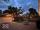 Evening shot of the backyard featuring string lights, garage, and patio area at 5224 Boulevard Pl, Indianapolis, IN 46208