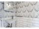 Bathroom featuring a sleek wall-mounted sink, white subway tile, and modern fixtures at 5224 Boulevard Pl, Indianapolis, IN 46208