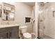 Modern bathroom with glass-enclosed shower, gray vanity, modern fixtures, and neutral decor at 5224 Boulevard Pl, Indianapolis, IN 46208
