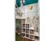 Playful bedroom features a loft bed with ladder, built-in bookshelf steps, and whimsical wallpaper at 5224 Boulevard Pl, Indianapolis, IN 46208