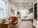Airy bedroom with a cozy sitting area, neutral color scheme, and hardwood flooring at 5224 Boulevard Pl, Indianapolis, IN 46208