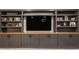 Custom built-in shelving with sleek gray cabinets and a light wood countertop at 5224 Boulevard Pl, Indianapolis, IN 46208