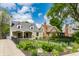 Attractive exterior view of home with stone facade, nice landscaping, and black fence at 5224 Boulevard Pl, Indianapolis, IN 46208