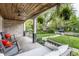 Cozy covered front porch with swing, chairs, and lovely views of the yard at 5224 Boulevard Pl, Indianapolis, IN 46208