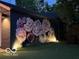 Garage with a floral mural and accent lighting to create a unique backyard feature at 5224 Boulevard Pl, Indianapolis, IN 46208