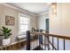 Hallway featuring hardwood floors, natural light, and stylish decor at 5224 Boulevard Pl, Indianapolis, IN 46208
