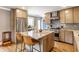 A modern kitchen showcases an island, stainless steel appliances, and stylish cabinetry at 5224 Boulevard Pl, Indianapolis, IN 46208