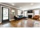 Comfortable living room with hardwood floors, fireplace, and large windows at 5224 Boulevard Pl, Indianapolis, IN 46208