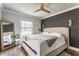 This spacious main bedroom features hardwood floors, a ceiling fan, and decorative lighting at 5224 Boulevard Pl, Indianapolis, IN 46208