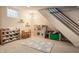 Bright playroom with play kitchen, cloud rug, cloud shelves, toy storage, and room for activities at 5224 Boulevard Pl, Indianapolis, IN 46208