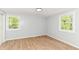 Bright bedroom with hardwood floors and two windows offering a refreshing view at 5721 Daphne Dr, Indianapolis, IN 46278