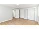 Bedroom featuring hardwood floors, fresh gray paint and two closet doors at 5721 Daphne Dr, Indianapolis, IN 46278