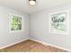 Sunny room features wood-look flooring, two windows offering views of lush greenery at 5721 Daphne Dr, Indianapolis, IN 46278