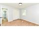 Bright bedroom featuring wood-look flooring, a closet, and a window, creating a comfortable living space at 5721 Daphne Dr, Indianapolis, IN 46278