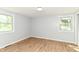 Inviting room featuring wood-look flooring and dual windows offering bright natural light at 5721 Daphne Dr, Indianapolis, IN 46278