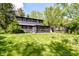 The backyard of a multi-story home featuring green lawn and an enclosed patio at 5721 Daphne Dr, Indianapolis, IN 46278