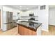 Well-appointed kitchen with a center island, stainless steel appliances, sleek countertops, and stylish backsplash at 5721 Daphne Dr, Indianapolis, IN 46278